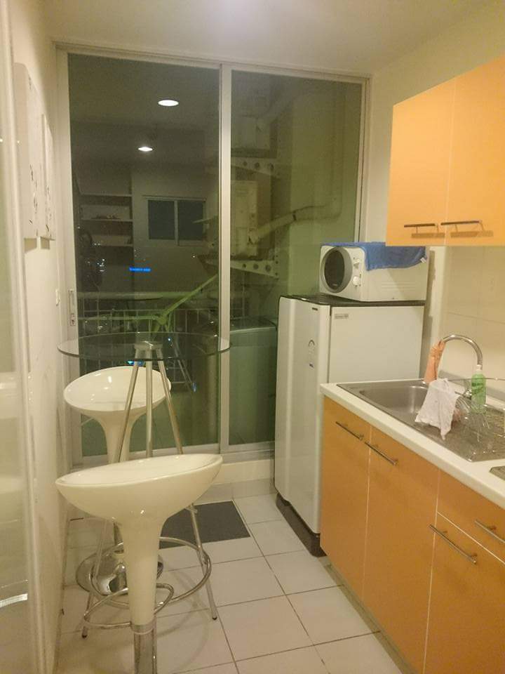 Kitchen area with bar stand and stools