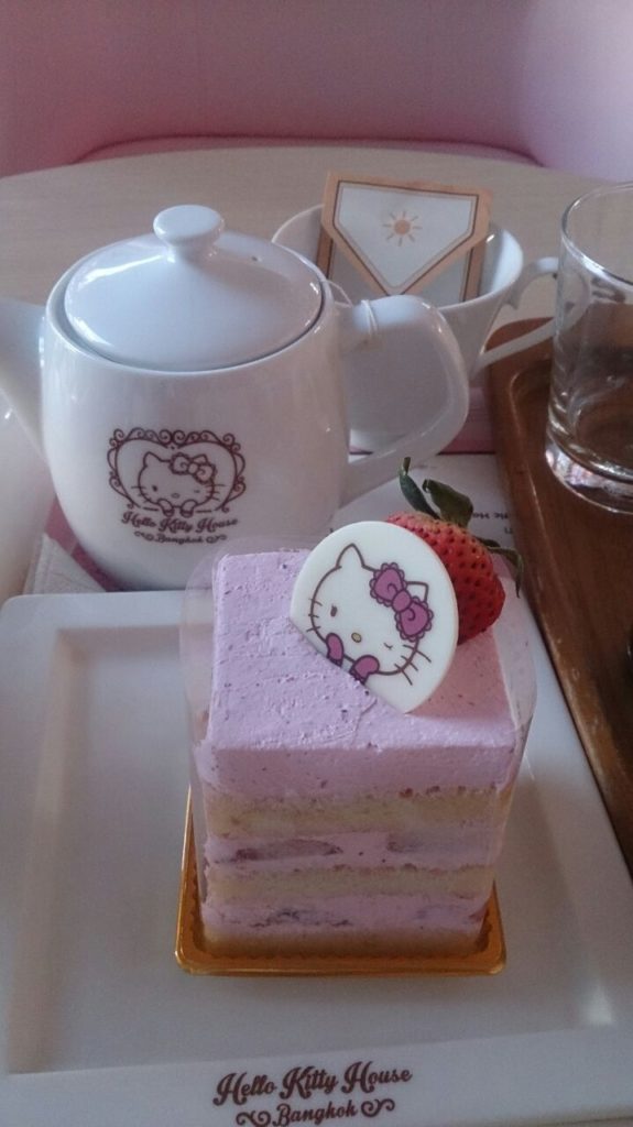 Another close up of the slice of cake and hot tea pot